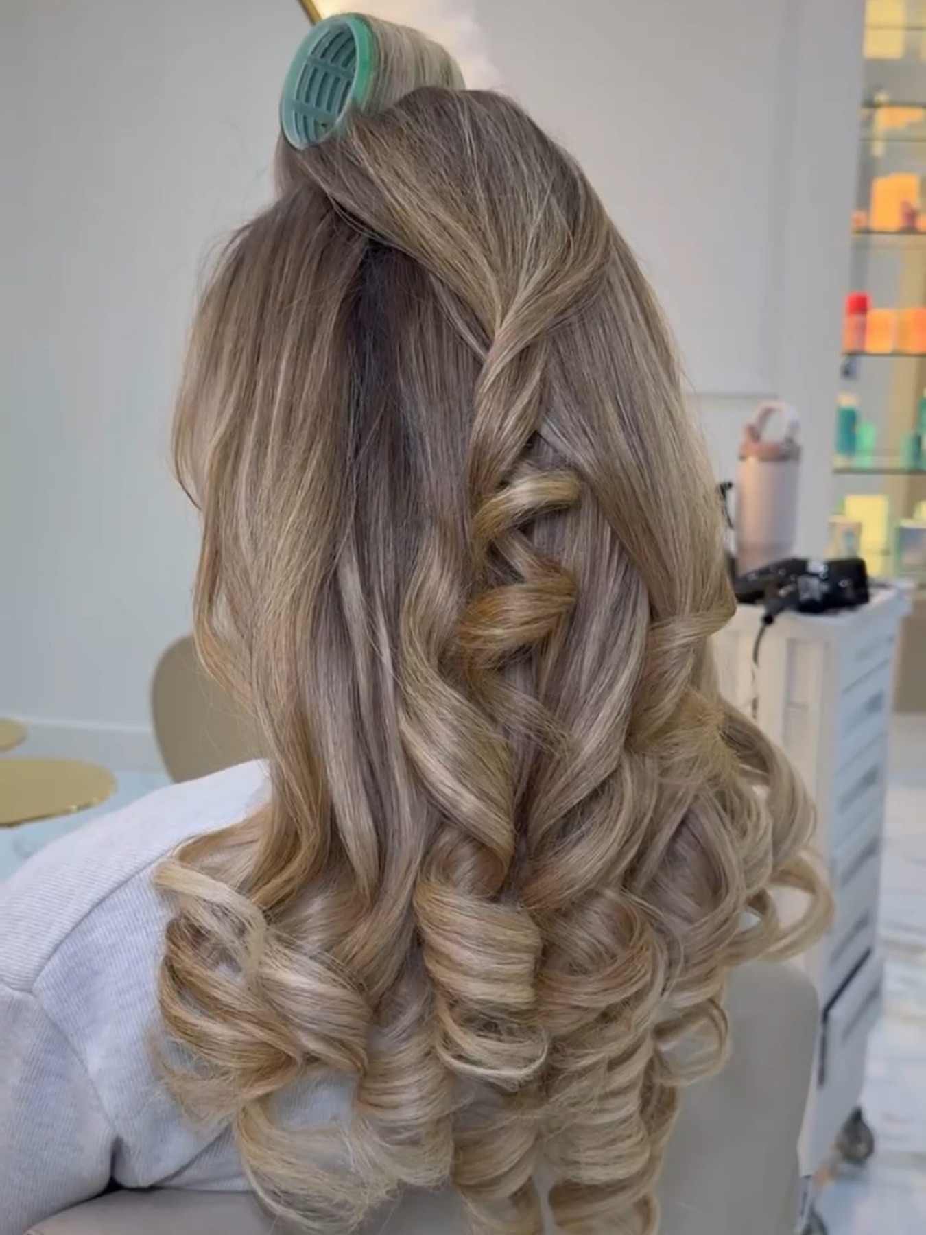 Blonde bouncy blow dry with soft curls and volume.