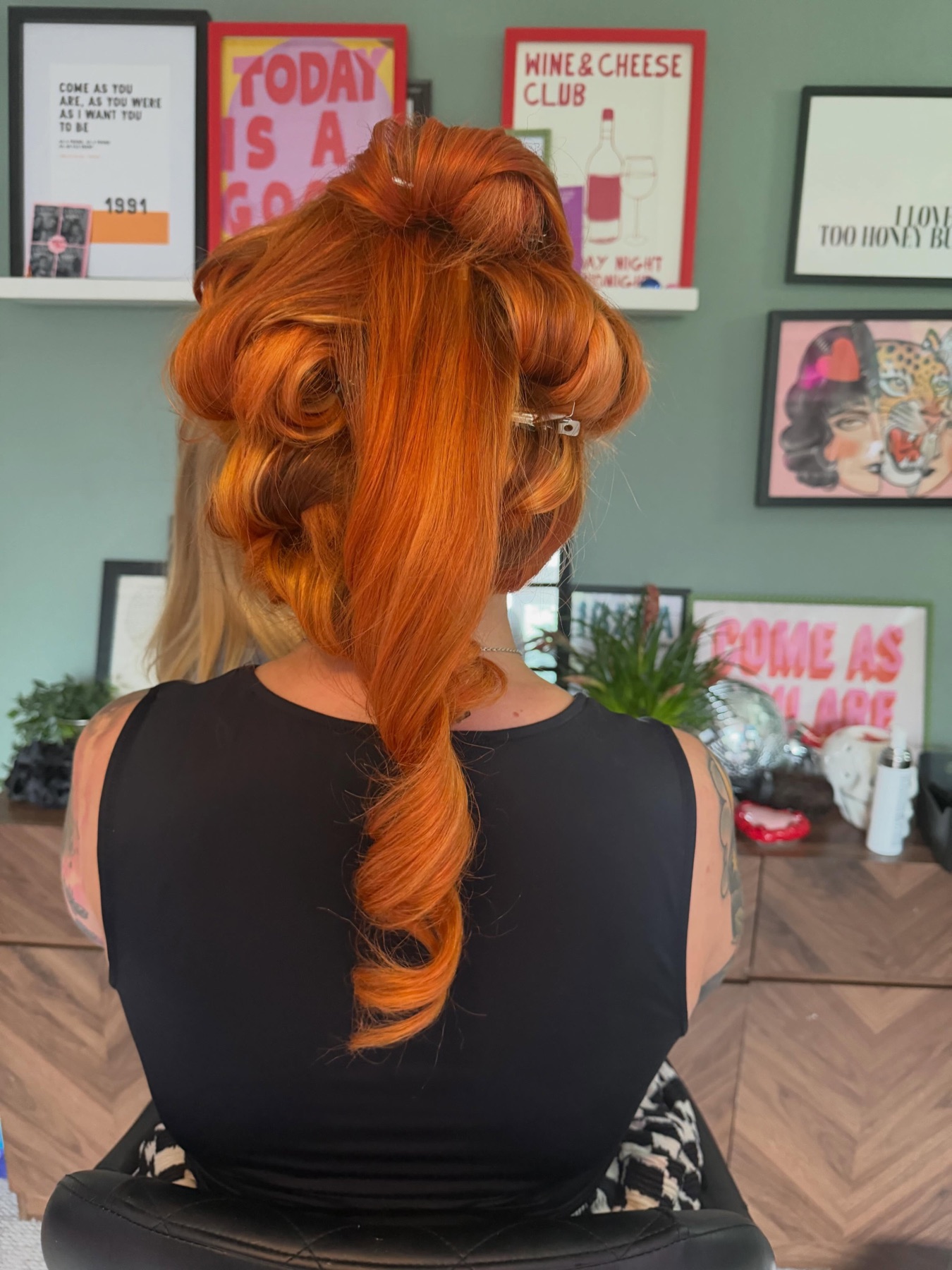 Copper blow dry styled with pinned volume and a smooth curl.